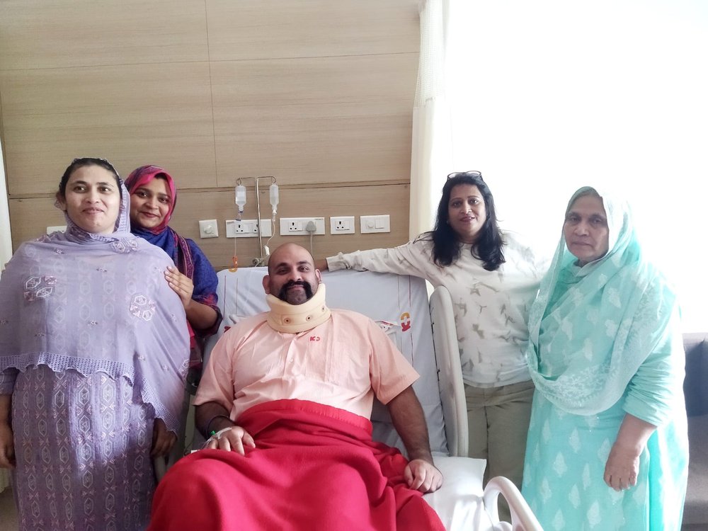 A patient recovering in hospital with family by his side